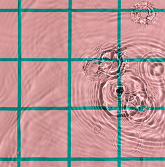 Water texture on pink checkered pattern background on the noon sunlight.