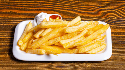 Fries on plate with ketchup and mayonnaise