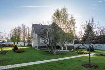 Russian dacha with cottage, garden, vegetable garden, lawn and footpaths.
