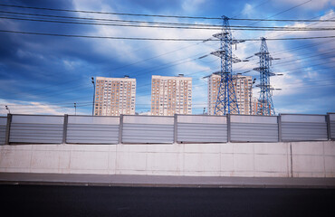 Industrial power lines in city background