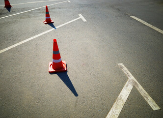 Road cones at empty parking transportation lines backdrop