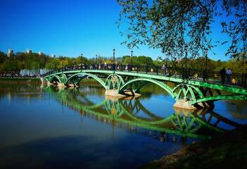 Park bridge with dramatic water reflections landscape backdrop