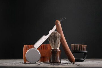 Moustache and beard styling tools on wooden table