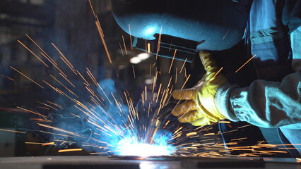 A worker welding the metal.