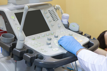 Mammologist conducting ultrasound examination of woman's breast in clinic, closeup