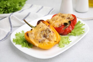 Delicious stuffed peppers on white table, closeup
