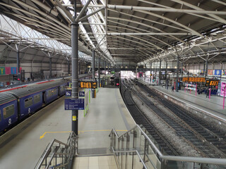 Leeds railway station, UK, moving trains waiting to depart, gray rails, transport, travel, city,...