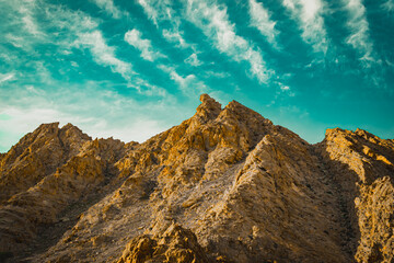 sunset in the mountains, landscape with sky, beautiful rock with blue sky during daytime