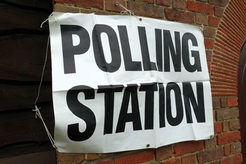 UK polling station sign attached to community hall wall