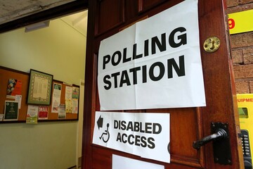UK polling station sign on the door of a village hall