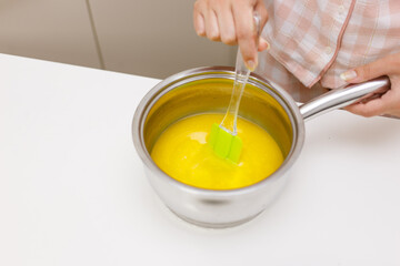 Young girl is cooking breakfast in the kitchen