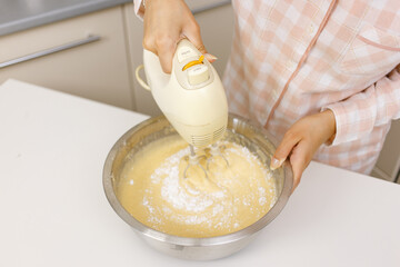 Young girl is cooking breakfast in the kitchen