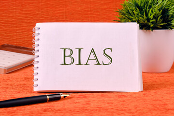 Personal opinions prejudice bias. Concept Bias on a white notebook on an orange background