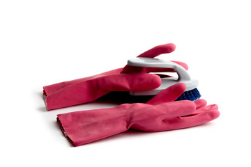 pink rubber gloves and a bristle brush ready for cleaning isolated on white