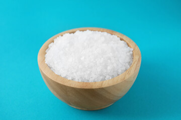 Organic white salt on light blue background, closeup