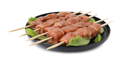 Wooden skewers with cut raw marinated meat isolated on white