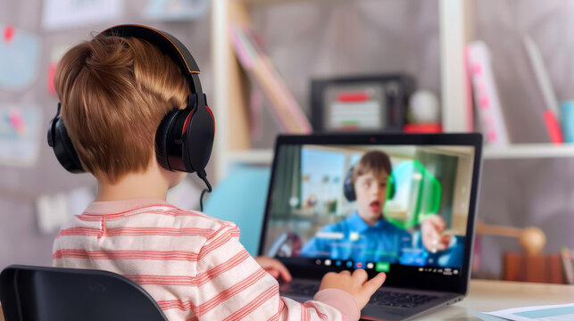 Young boy with headphones using laptop for online learning, showing another boy holding a globe