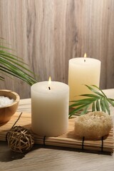 Composition with spa supplies and palm leaves on wooden table