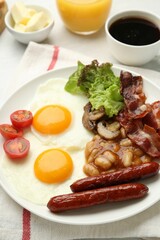 Delicious breakfast with sunny side up eggs on white table, closeup