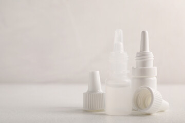 Bottle of medical drops on white background, space for text