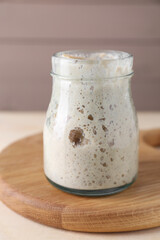 Sourdough starter in glass jar on table