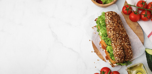 Delicious sandwich with schnitzel on white table, flat lay. Banner design with space for text