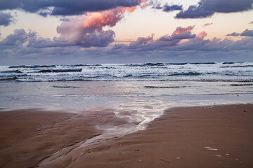 Fototapeta premium Puddles at sunset on the beach of Denia