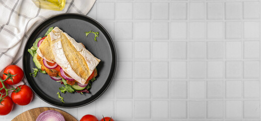 Delicious sandwich with schnitzel on white tiled table, flat lay. Banner design with space for text