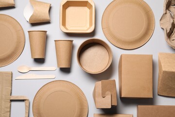 Eco friendly food packaging. Paper containers, bag and tableware on light grey background, flat lay