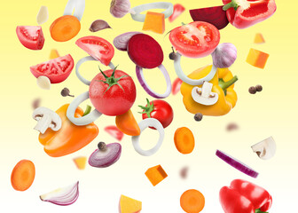 Different fresh vegetables in air on yellow gradient background