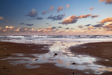 Puddles at sunset on the beach of Denia