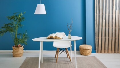 Modern minimalistic reading table in reading corner in living room with beautiful blue walls and flower vase
