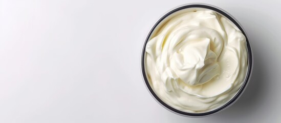 A bowl of Greek-styled sour cream on a white background