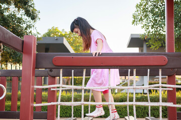 Cute asian girl playing in the playground