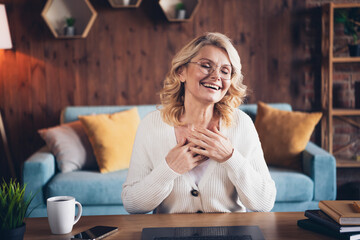 Portrait of aged lady laugh chatting video call wear white cardigan loft interior house indoors
