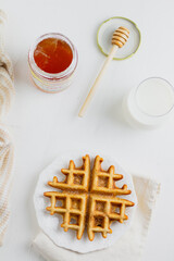 Waffle with honey. Aesthetic composition. Food Styling.