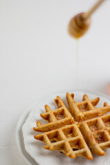 Waffle with honey. Aesthetic composition. Food Styling.