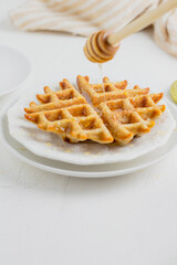 Waffle with honey. Aesthetic composition. Food Styling.