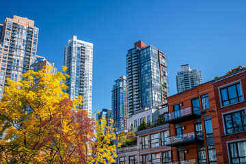 Midday brings a vibrant view of historic buildings contrasted with modern apartments under a blue sky.