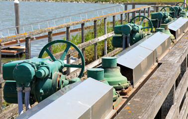 numerous sluice gate valves for water regulation in the flood control basin.