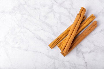 Ceylon cinnamon.Cinnamon sticks on a textured wooden background. Cinnamon roll and powder. Spicy spice for baking, desserts and drinks. Fragrant ground cinnamon. Close-up. Place for text. copy space