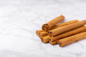 Ceylon cinnamon.Cinnamon sticks on a textured wooden background. Cinnamon roll and powder. Spicy spice for baking, desserts and drinks. Fragrant ground cinnamon. Close-up. Place for text. copy space
