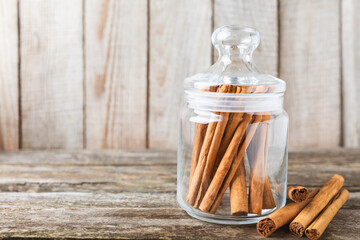 Ceylon cinnamon.Cinnamon sticks on a textured wooden background. Cinnamon roll and powder. Spicy...