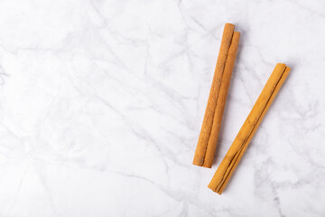 Ceylon cinnamon.Cinnamon sticks on a textured wooden background. Cinnamon roll and powder. Spicy spice for baking, desserts and drinks. Fragrant ground cinnamon. Close-up. Place for text. copy space