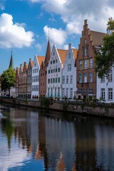 Fototapeta premium A row of houses situated next to a body of water. Ideal for real estate or travel concepts