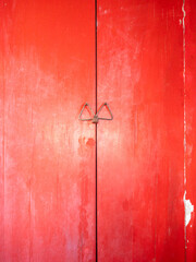 The red wooden door locked by a padlock