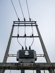 The electrical transformer installed on the concrete pole.