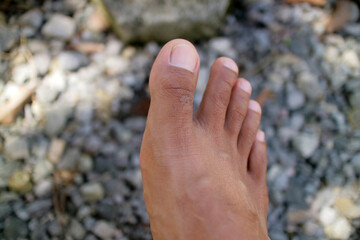 a man legs in dark brown. Asian man. gravel background