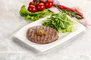 Frilled beef burger cutlet with iceberg
