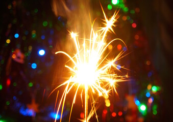 Sparkling sparklers at night. Bright Christmas background. A festive event.